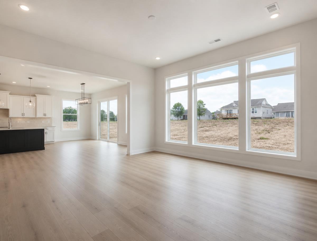 Empty new build interior with bare windows and unfinished backyard